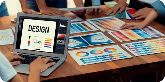 Graphic design services represented by creative professionals reviewing digital layouts and color palettes