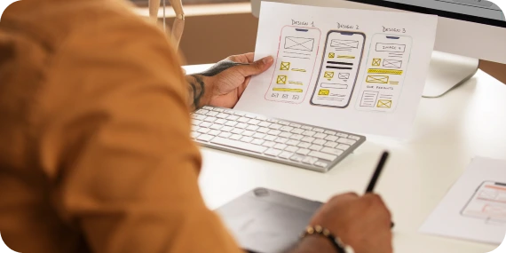 Mobile app development services illustrated by a designer planning application interfaces and wireframes